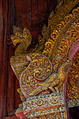 Chiang Mai - The Wat Phra Singh temple. Detail of the entrance door of the ubosot (ordination hall). 